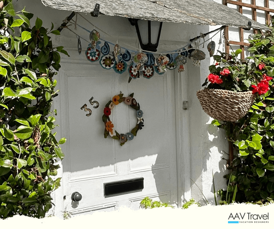 Charming Cornish cottage door adorned with climbing greenery and seaside accents